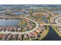 Beautiful aerial view of a home nestled among lush landscaping, lakes, and a golf course community at 26720 Weiskopf Dr, Englewood, FL 34223
