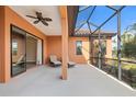 A covered outdoor living space with comfortable seating and scenic backyard views at 26720 Weiskopf Dr, Englewood, FL 34223