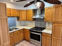 Traditional kitchen featuring wood cabinets, stainless steel appliances, and patterned backsplash at 4127 3Rd Ave W, Palmetto, FL 34221