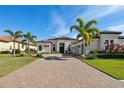 Beautiful one-story home featuring well-manicured landscaping and a neutral color scheme at 4745 Benito Ct, Lakewood Ranch, FL 34211