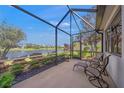 Relaxing screened-in patio overlooking a serene pond and lush landscaping at 531 Latitude Ln, Osprey, FL 34229