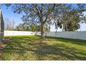 Spacious backyard with mature tree and privacy fence at 5561 Burnt Branch Cir, Sarasota, FL 34232