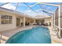 Screened lanai with pool, stone deck, covered dining area and comfortable seating at 557 Marsh Creek Rd, Venice, FL 34292