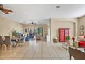 Spacious living room featuring tile floors, neutral paint, and multiple seating areas at 9214 Raes Creek Pl, Palmetto, FL 34221