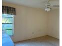 Cozy bedroom with a window overlooking the neighborhood at 1546 Grand Blvd # 108, Sarasota, FL 34232