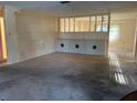 Spacious living room with a partial wall and neutral color scheme at 1546 Grand Blvd # 108, Sarasota, FL 34232