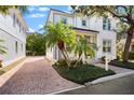 Charming home featuring a brick driveway, tropical landscaping, and a well-maintained lawn at 1746 Stapleton St, Sarasota, FL 34239