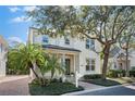 Charming home featuring tropical landscaping, a welcoming porch, and a well-maintained lawn at 1746 Stapleton St, Sarasota, FL 34239
