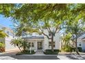 Charming two-story home featuring manicured landscaping, a welcoming porch, and a well-maintained front yard at 1746 Stapleton St, Sarasota, FL 34239