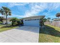 Single-story home with a spacious driveway, two-car garage, and manicured lawn at 4410 70Th E Dr, Sarasota, FL 34243