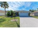 Charming single-story home boasts an attached two-car garage, beautiful landscaping and a well-manicured lawn at 4410 70Th E Dr, Sarasota, FL 34243