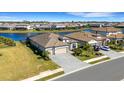 Aerial view of home showing a lake view, three-car garage, and meticulous landscaping at 5035 Seafoam Trl, Bradenton, FL 34211