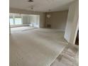 Expansive living room featuring lots of natural light and adjoining rooms at 600 S Neponsit Dr, Venice, FL 34293