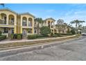 Inviting townhome exteriors showcasing private balconies, landscaped yards, and street parking at 1605 Napoli W Dr, Sarasota, FL 34232
