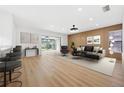 Open-concept living room with wood floors, sliding doors to the outdoor space, and a modern accent wall at 2321 Beneva Ter # 2288, Sarasota, FL 34232