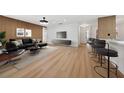 Bright living room featuring modern decor, wood-look floors, sleek furniture, and a stylish accent wall at 2321 Beneva Ter # 2288, Sarasota, FL 34232