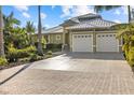 Charming single-story home with a three-car garage, paver driveway, and well-manicured landscaping at 2500 Jamaica St, Sarasota, FL 34231