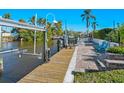 Waterfront view from a private boat dock, featuring a boat lift, wooden walkway, and access to open water at 5303 Coral Blvd, Bradenton, FL 34210