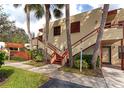 Building exterior featuring a stairway, landscaping, and visible unit number at 535 Spring Lakes Blvd, Bradenton, FL 34210