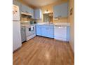 Bright kitchen with blue cabinets and white appliances at 535 Spring Lakes Blvd, Bradenton, FL 34210