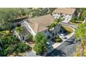 Inviting two-story villa with tile roof, lush landscaping, and a private driveway for convenient parking at 6706 Fairway Gardens Dr # 6706, Bradenton, FL 34203