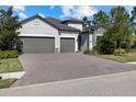 Charming single-Gathering home with a 2-car garage, stone accents, and a brick paver driveway at 12029 Perennial Pl, Lakewood Ranch, FL 34211