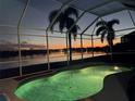 Enclosed pool and spa area offers stunning twilight views over the lake creating a picturesque setting at 6920 74Th Street E Cir, Bradenton, FL 34203