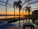 Screened pool area features a luxurious pool with beautiful sunset views and space for outdoor relaxation at 6920 74Th Street E Cir, Bradenton, FL 34203