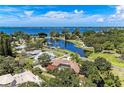 Stunning aerial view showcases a beautiful home with a pool overlooking scenic waterways and lush surroundings at 7820 Seville Cir, Bradenton, FL 34209