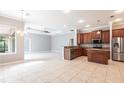 Open concept kitchen featuring stainless steel appliances, granite counters, and tile flooring at 2111 152Nd E Ct, Bradenton, FL 34212