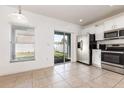 Eat-in kitchen area offering stainless steel appliances, a sliding glass door to the backyard, and plenty of natural light at 2347 Richwood Pike Dr, Ruskin, FL 33570