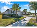 A street view showcasing multiple single-Gathering homes, each featuring similar landscaping at 3747 Laughing Dove Ave, Sun City Center, FL 33573