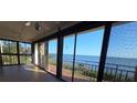 Bright enclosed porch offering amazing waterfront views through large sliding glass doors at 6430 Sun Eagle Ln # 201, Bradenton, FL 34210