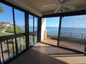 Enclosed porch featuring stunning waterfront views, glass windows, and a ceiling fan at 6430 Sun Eagle Ln # 201, Bradenton, FL 34210