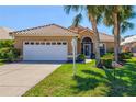 Charming home with a well-manicured lawn and mature palm trees in a desirable neighborhood at 1364 Berkshire Ct, Venice, FL 34292