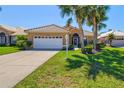 Beautifully landscaped home with a two-car garage and a meticulously maintained front yard at 1364 Berkshire Ct, Venice, FL 34292