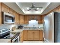 Well-lit kitchen featuring stainless steel appliances and light wood cabinets, offering a functional cooking space at 1430 57Th W St # 1430, Bradenton, FL 34209
