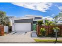 Modern gray and white home with a two-car garage, unique landscaping, and contemporary architectural design at 2254 Hawthorne St, Sarasota, FL 34239