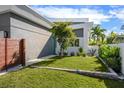 View of the well maintained front lawn featuring contemporary landscaping at 2254 Hawthorne St, Sarasota, FL 34239