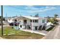 Charming single-story home with a covered front porch, well-maintained landscaping, and ample parking at 2601 Gulf N Dr # 427, Bradenton Beach, FL 34217