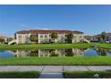 Waterfront condo building with lush landscaping and reflection on water at 2950 Viscaya Pl # 205, Sarasota, FL 34237