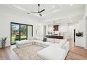 Bright open-concept living room featuring a large sectional sofa and seamless flow to the kitchen at 3598 Trinity St, North Port, FL 34291