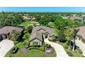 An aerial view of the attractive tan-colored home in a neighborhood with a golf course nearby at 5304 96Th E St, Bradenton, FL 34211