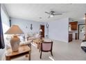 Inviting living room with a ceiling fan, neutral walls, and ample natural light creating a warm atmosphere at 5808 13Th Street E Ct, Bradenton, FL 34203
