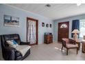 Cozy living room featuring natural light, wood-trimmed doorways, and comfortable seating at 5808 13Th Street E Ct, Bradenton, FL 34203