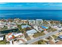 Waterfront home featuring lush landscaping, ocean views, and serene street access at 609 Foxworth Ln, Holmes Beach, FL 34217