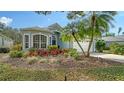 Charming home featuring a two-car garage, vibrant landscaping, and a beautifully maintained front yard at 92 Tall Trees Ct, Sarasota, FL 34232