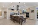 Spacious kitchen with large center island, breakfast bar, stainless steel appliances, and ample counter space at 1359 Tearose Pl, Sarasota, FL 34239