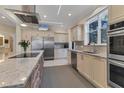 Bright, airy kitchen featuring stainless steel appliances, granite countertops, and modern cabinetry at 1359 Tearose Pl, Sarasota, FL 34239