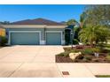 Charming single-story home with a well-manicured lawn, featuring a two-car garage and beautiful tropical landscaping at 2006 Red Lake Run, Bradenton, FL 34211
